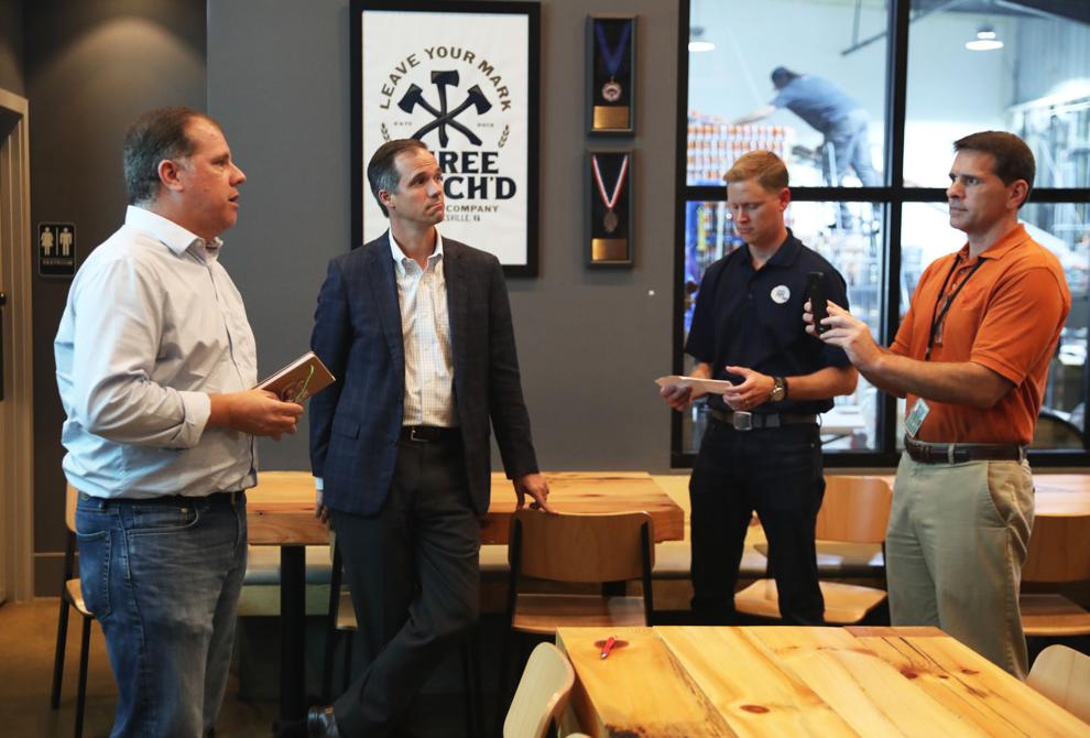 Storyware representative Todd Wickersty (left) speaks during a press conference announcing the opening of the Charlottesville Ale Trail on Tuesday. The trail features six local breweries within walking distance of the Downtown Mall.